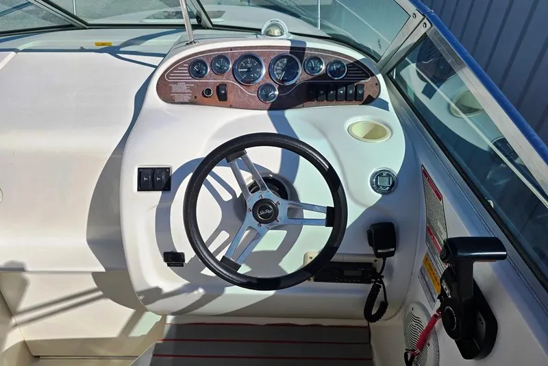 Slide: The Image of 1997 Sea Ray 240 Sundancer boat dashboard with steering wheel and instrument panel. - 22