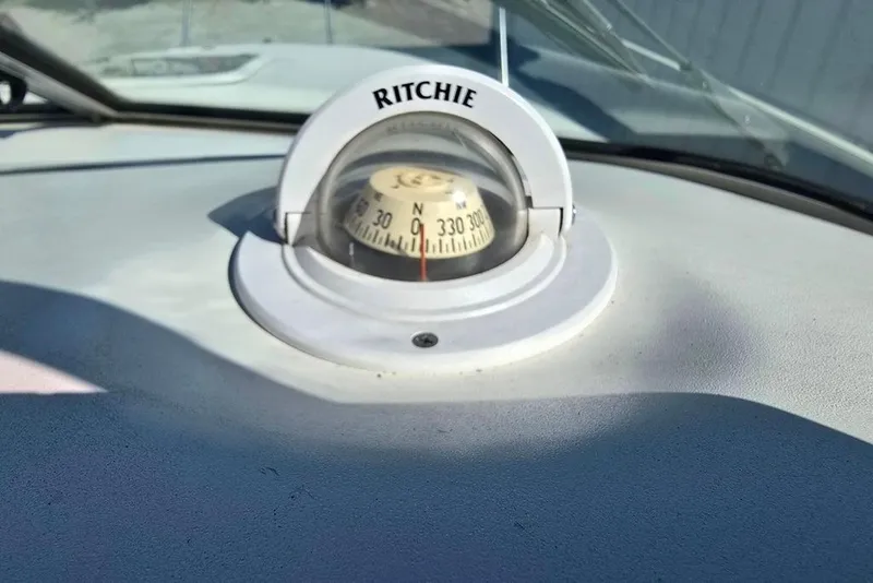 Slide: The Image of Ritchie compass on 1997 Sea Ray 240 Sundancer boat dashboard. - 25