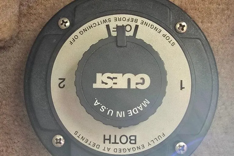 Slide: The Image of Battery switch on a 1997 Sea Ray 240 Sundancer boat, labeled "Guest" and "Made in U.S.A." - 27