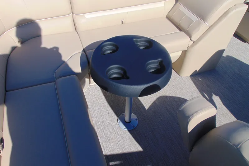 Slide: The Image of Interior of 2026 Godfrey EX 1880 Cruise with beige seating and cup holder table. - 13