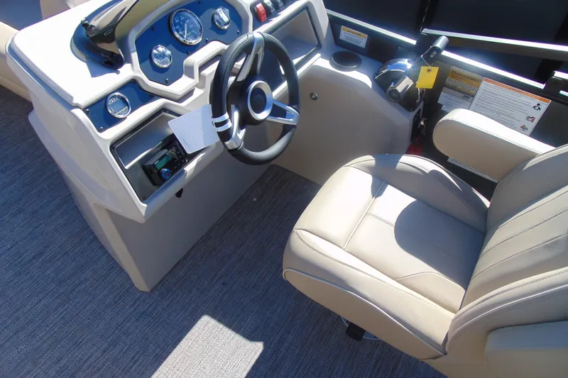 Slide: The Image of 2026 Godfrey EX 1880 Cruise boat dashboard and captain's chair, featuring modern controls. - 9