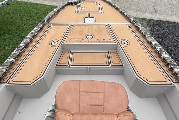 Slide: The Image of 2026 Avid 21 FSX boat interior with cushioned seating and wood-patterned deck. - 10