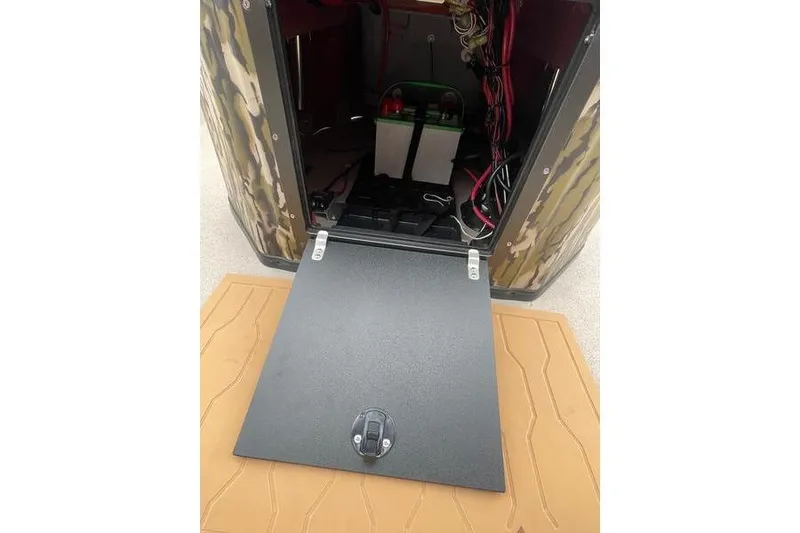 Slide: The Image of Open compartment of 2026 Avid 21 FSX boat showing battery and wiring. - 12