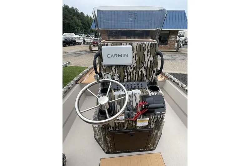 Slide: The Image of Avid 21 FSX 2026 boat console with Garmin navigation, camo design, and steering wheel. - 14