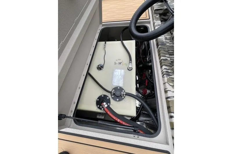 Slide: The Image of Fuel tank compartment of 2026 Avid 21 FSX boat, showing hoses and wiring. - 15