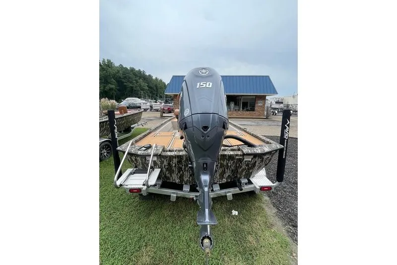 Slide: The Image of 2026 Avid 21 FSX boat with 150 HP engine on trailer, parked outdoors. - 6