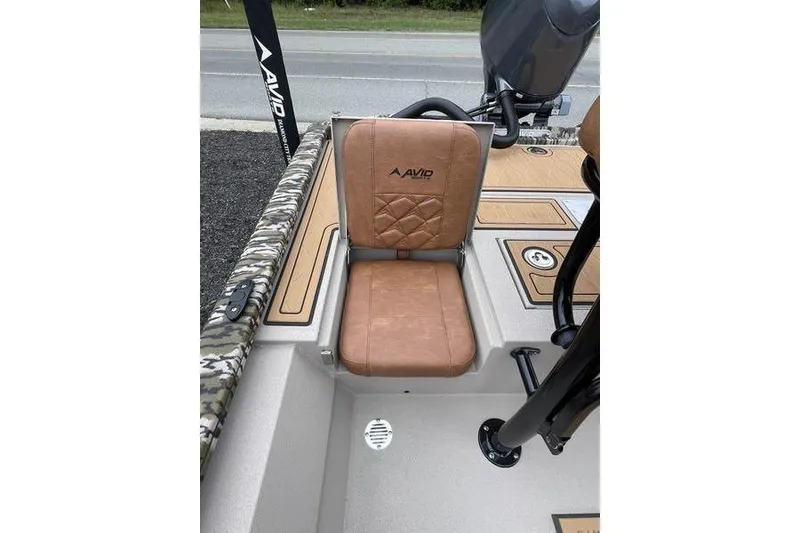 Slide: The Image of 2026 Avid 21 FSX boat seat with tan upholstery and camo accents. - 7