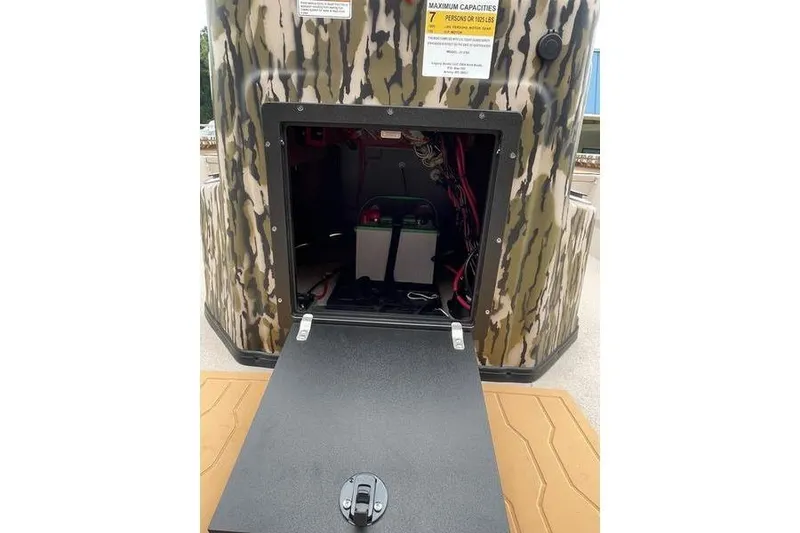 Slide: The Image of Open storage compartment of 2026 Avid 21 FSX boat with camouflage exterior. - 8