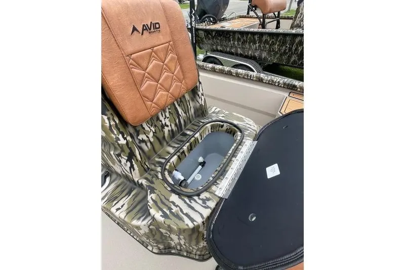 Slide: The Image of 2026 Avid 21 FSX boat seat with camouflage design and storage compartment. - 9