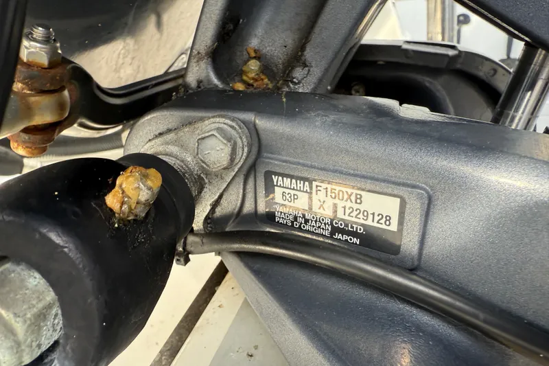 Slide: The Image of Close-up of Yamaha F150XB engine part on 2020 NauticStar 2602 Legacy boat. - 12