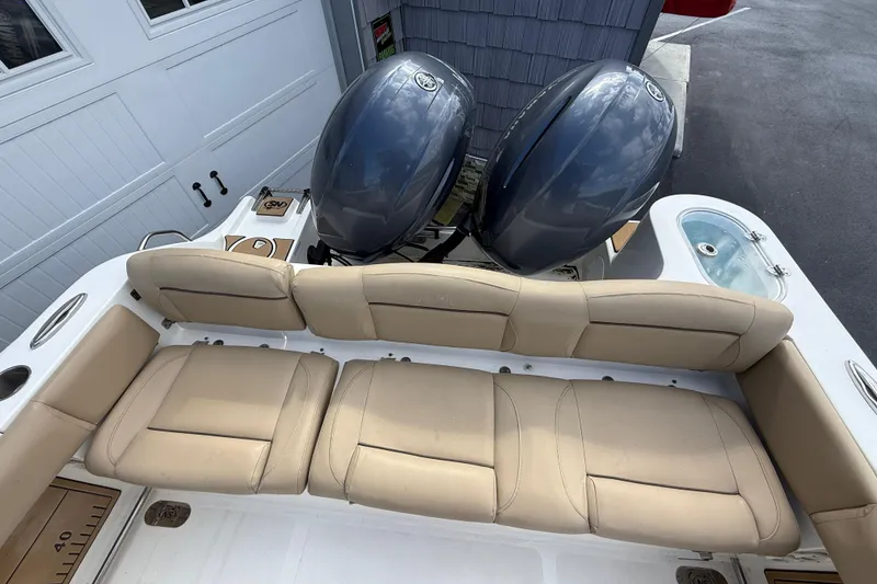 Slide: The Image of 2020 NauticStar 2602 Legacy boat with dual engines and beige seating. - 16