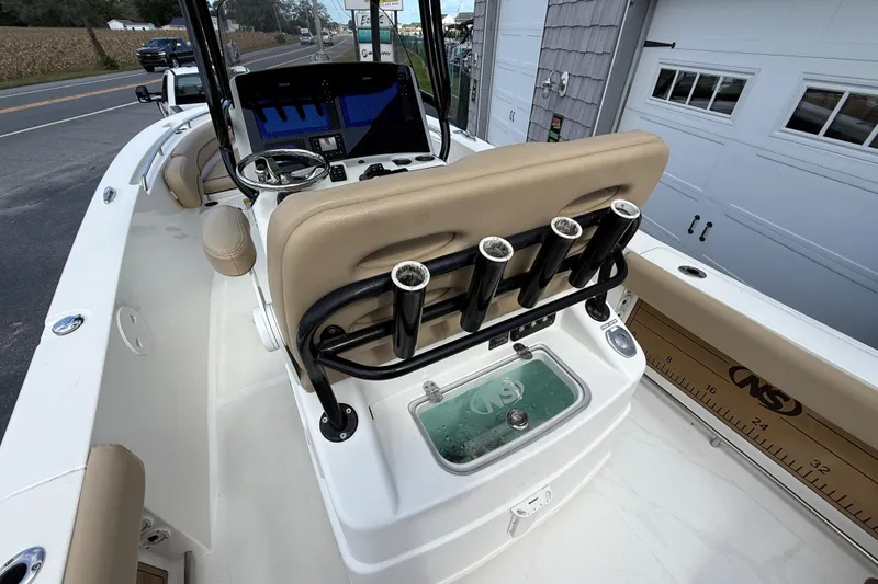 Slide: The Image of 2020 NauticStar 2602 Legacy boat interior with rod holders and navigation equipment. - 17