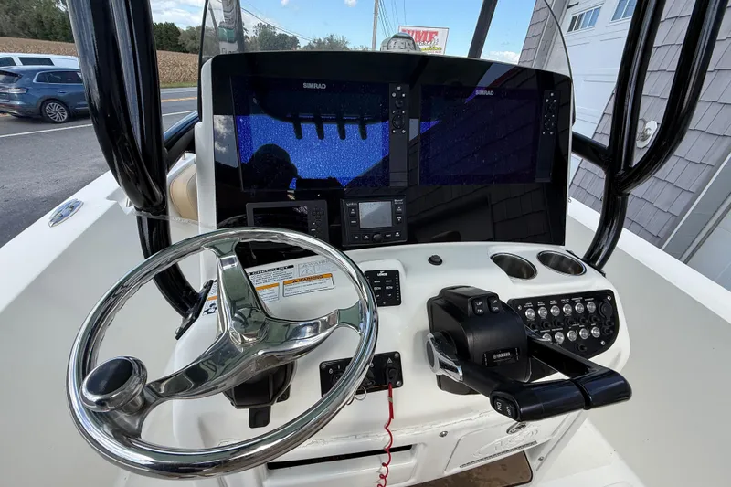 Slide: The Image of 2020 NauticStar 2602 Legacy boat dashboard with steering wheel and navigation controls. - 20