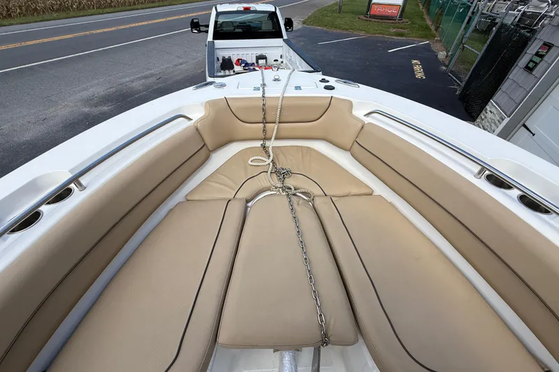 Slide: The Image of 2020 NauticStar 2602 Legacy boat interior with tan seating and anchor chain. - 22