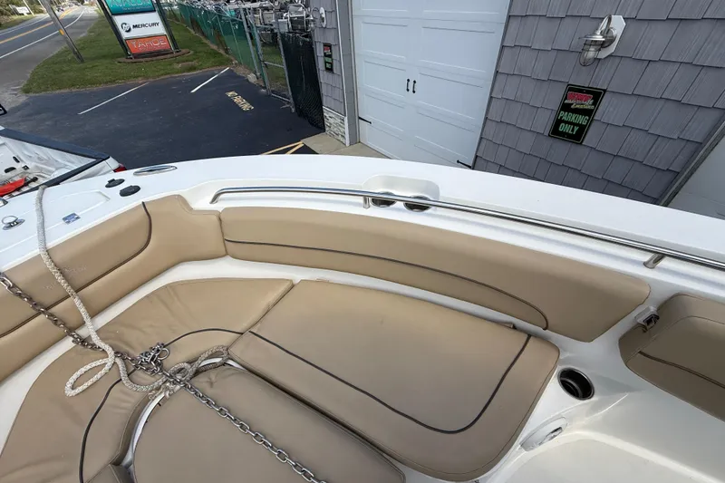 Slide: The Image of 2020 NauticStar 2602 Legacy boat interior with tan seating and metal railings. - 24