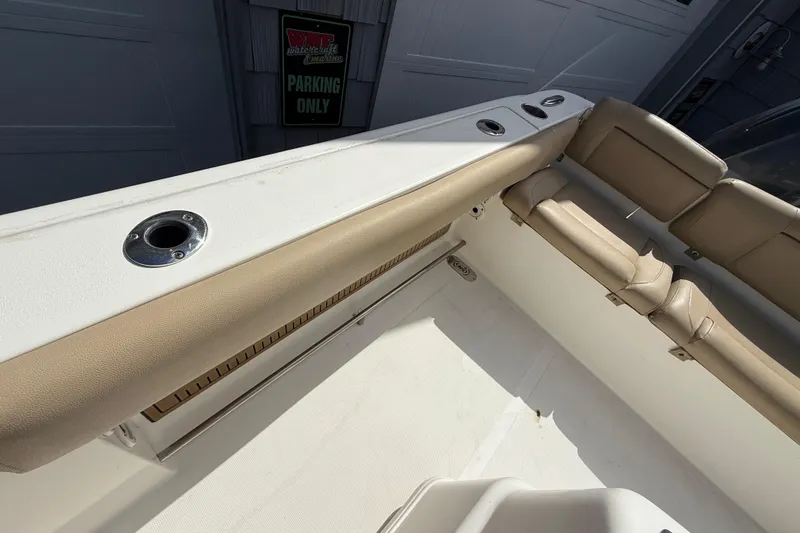 Slide: The Image of Interior view of a 2020 NauticStar 2602 Legacy boat with beige seating. - 28