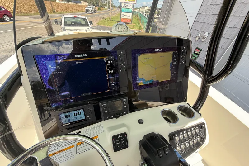 Slide: The Image of 2020 NauticStar 2602 Legacy boat dashboard with Simrad navigation displays. - 30