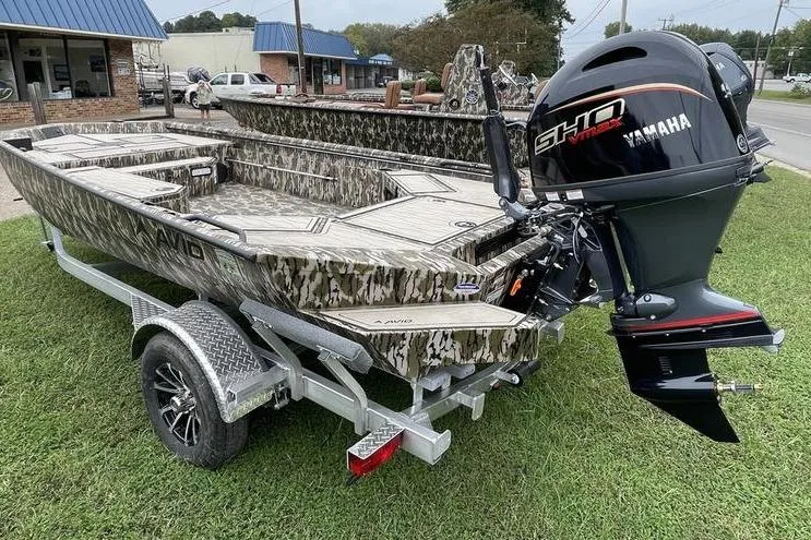 The Image of 2026 Avid 18 Commander boat with Yamaha engine on a trailer, parked on grass. - 0