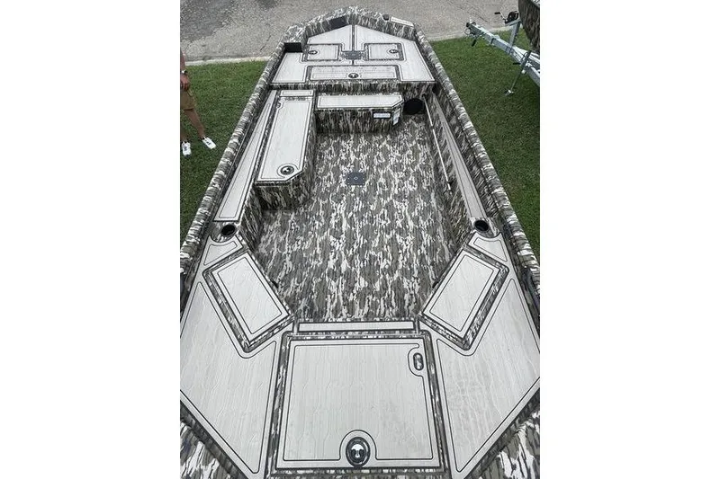 Slide: The Image of 2026 Avid 18 Commander boat interior with camouflage design and storage compartments. - 1