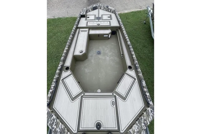 Slide: The Image of 2026 Avid 18 Commander boat interior with storage compartments and camouflage trim. - 3