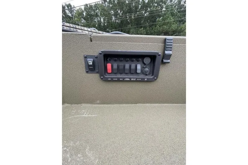 Slide: The Image of Control panel on 2026 Avid 18 Commander boat, featuring multiple switches and buttons. - 5