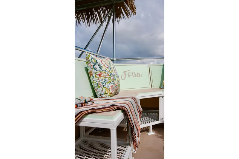 Slide: The Image of Cozy seating area on A&M Manufacturing Bulldog 43, 2027 model, with decorative pillows and blanket. - 11