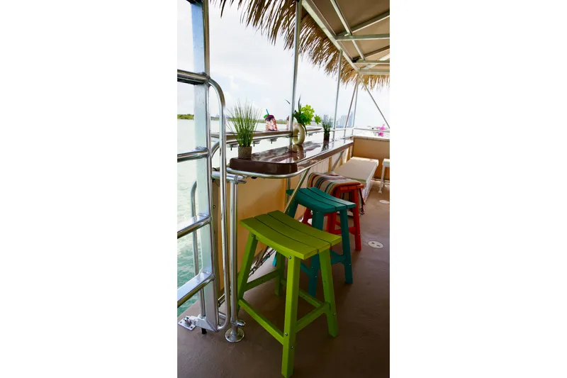 Slide: The Image of Colorful stools and plants on a 2027 A&M Manufacturing Bulldog 43 boat deck. - 13