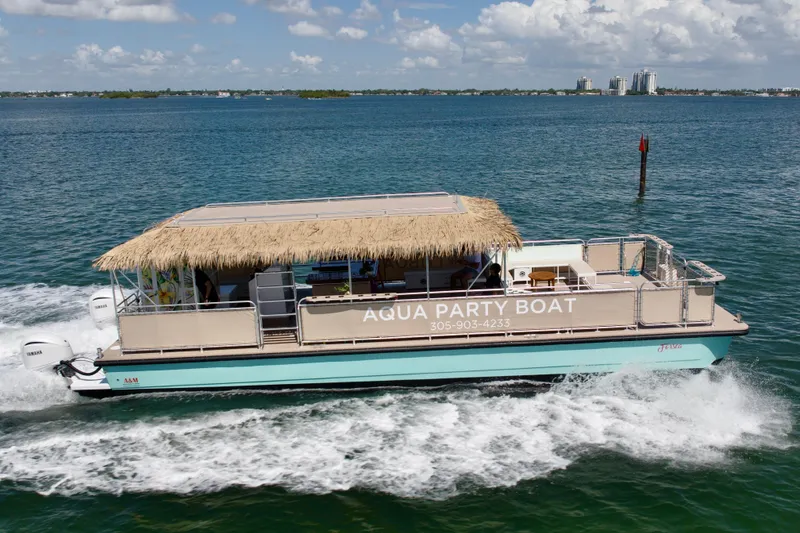 Slide: The Image of A&M Manufacturing Bulldog 43 Aqua Party Boat cruising on the water, 2027 model. - 6