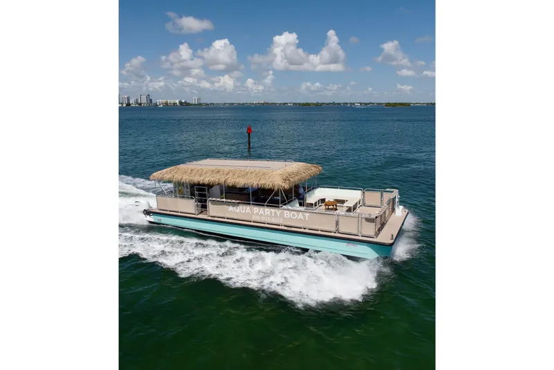 Slide: The Image of A&M Manufacturing Bulldog 43 party boat cruising on open water, 2027 model. - 7