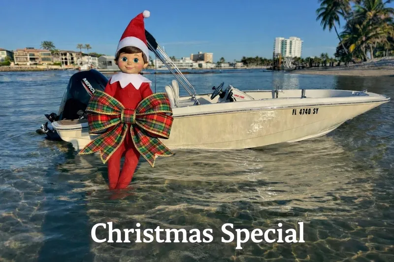 Slide: The Image of Elf on a Boston Whaler 160 Super Sport boat, Christmas theme, sunny waterfront. - 0