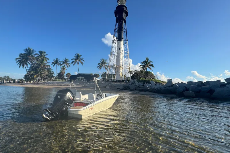 Slide: The Image of 2021 Boston Whaler 160 Super Sport near lighthouse and palm trees on a sunny day. - 10