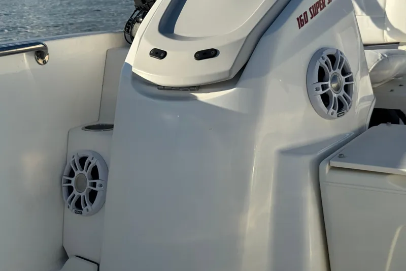 Slide: The Image of 2021 Boston Whaler 160 Super Sport interior with speakers and sleek design. - 13