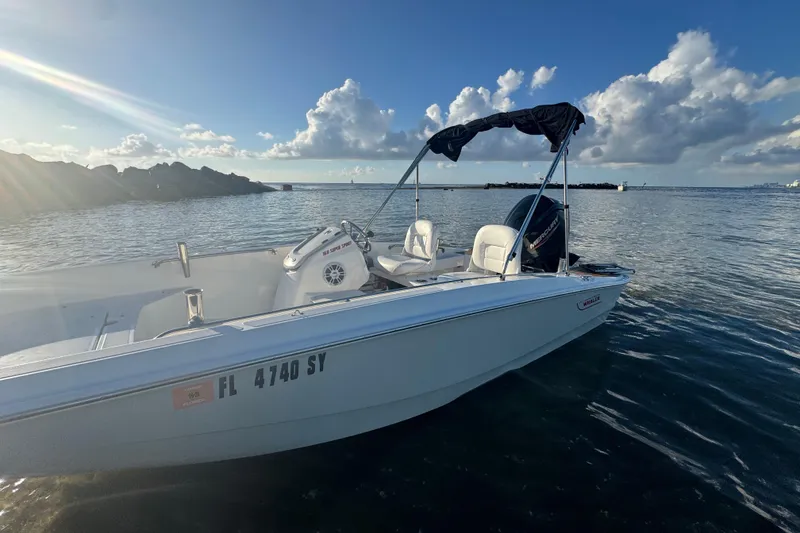 Slide: The Image of 2021 Boston Whaler 160 Super Sport boat interior with steering wheel and seating. - 15
