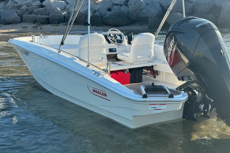 Slide: The Image of Steering wheel and control panel of 2021 Boston Whaler 160 Super Sport boat. - 19
