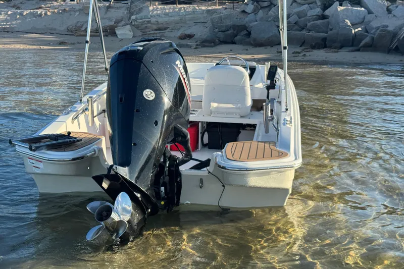 Slide: The Image of 2021 Boston Whaler 160 Super Sport steering console with water in the background. - 22