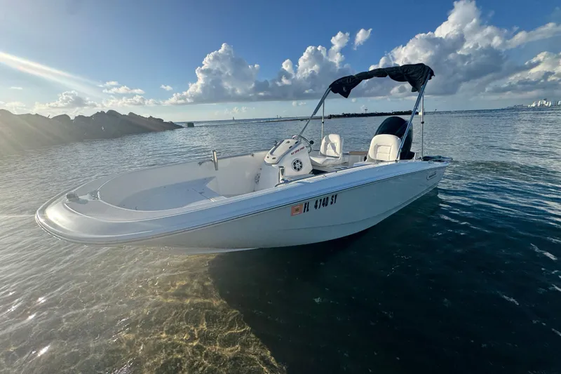 Slide: The Image of 2021 Boston Whaler 160 Super Sport boat on calm water under a clear sky. - 6