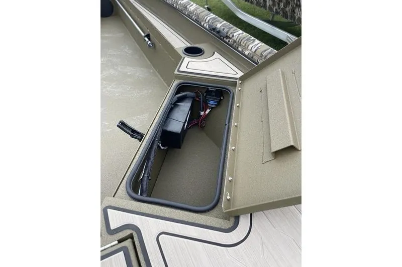 Slide: The Image of 2026 Avid 18 Commander boat storage compartment with battery and wiring. - 6