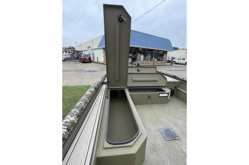 Slide: The Image of 2026 Avid 18 Commander boat interior with open storage compartments. - 9