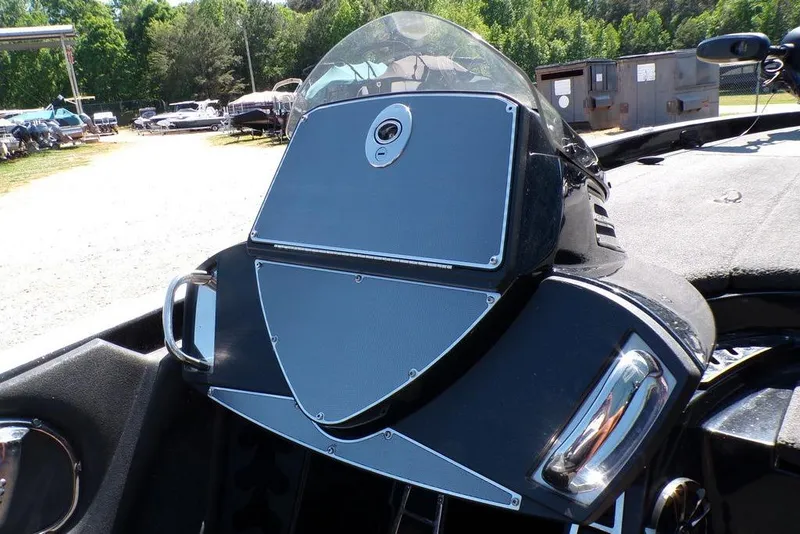 Slide: The Image of 2016 Ranger Z520 Comanche boat dashboard with windshield, outdoors in a sunny setting. - 16