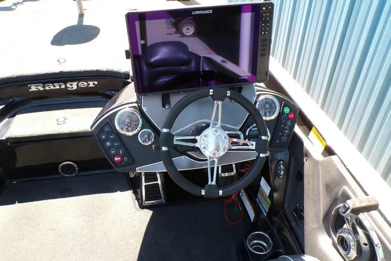 Slide: The Image of 2016 Ranger Z520 Comanche boat dashboard with steering wheel and Lowrance display. - 17