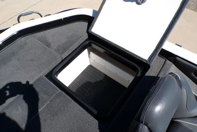 Slide: The Image of 2016 Ranger Z520 Comanche boat storage compartment with open lid, showing interior space. - 25