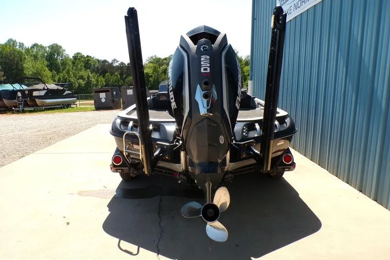 Slide: The Image of 2016 Ranger Z520 Comanche boat with Evinrude engine, parked outdoors near blue building. - 5