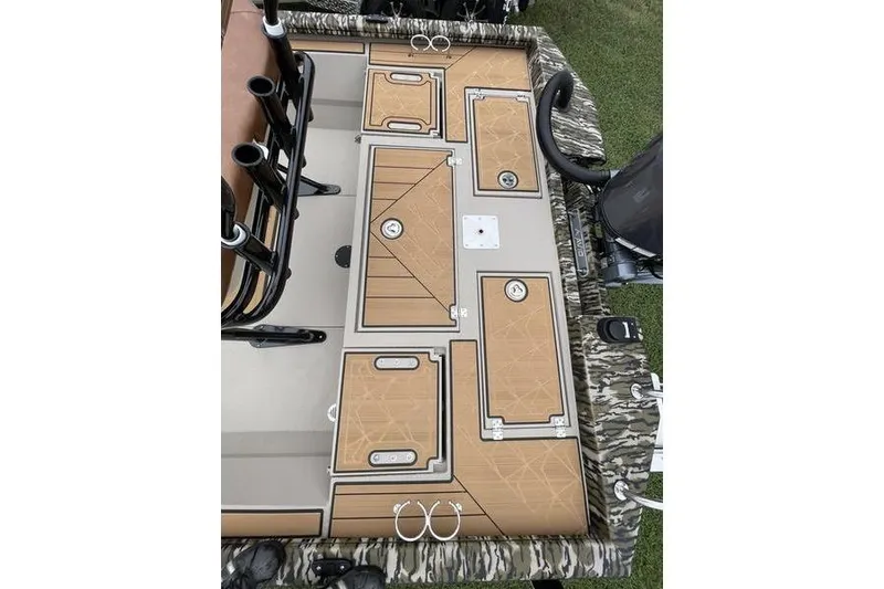 Slide: The Image of 2026 Avid 21 Fusion boat deck with storage compartments and camo trim. - 12