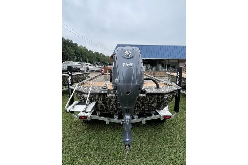 Slide: The Image of Avid 21 Fusion 2026 boat with Yamaha 150 engine, parked on grass. - 5