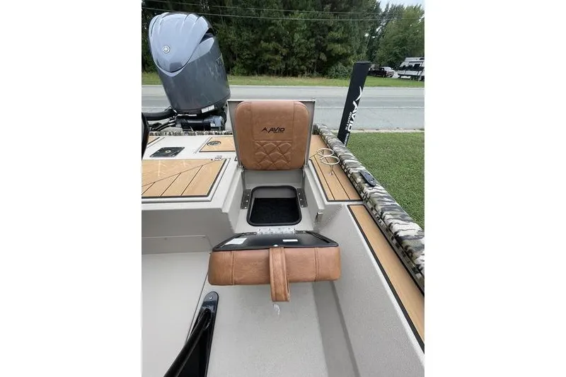 Slide: The Image of Avid 21 Fusion 2026 boat interior with tan leather seat and storage compartment. - 6