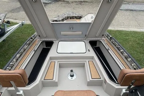 Slide: The Image of Avid 21 Fusion 2026 boat interior with open storage compartments and seating. - 8