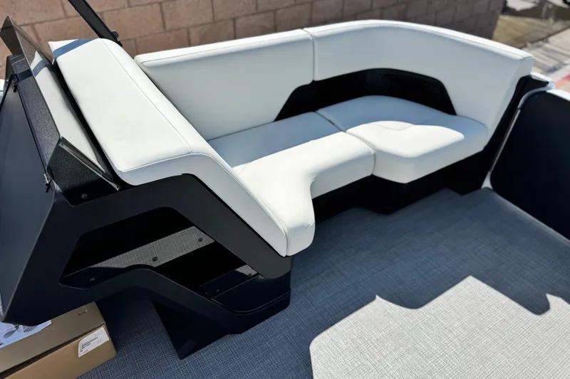 Slide: The Image of Luxurious seating on 2026 Manitou Cruise 22 Max pontoon boat, featuring sleek white upholstery. - 10