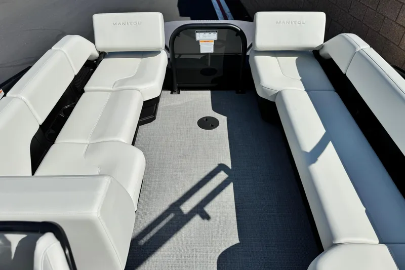 Slide: The Image of 2026 Manitou Cruise 22 Max pontoon boat interior with white seating and spacious layout. - 13