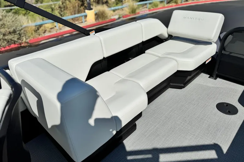 Slide: The Image of 2026 Manitou Cruise 22 Max boat interior with white seating and modern design. - 14