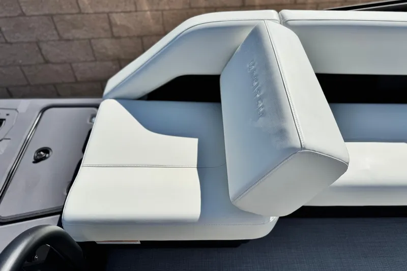 Slide: The Image of 2026 Manitou Cruise 22 Max boat seat with sleek white upholstery. - 16